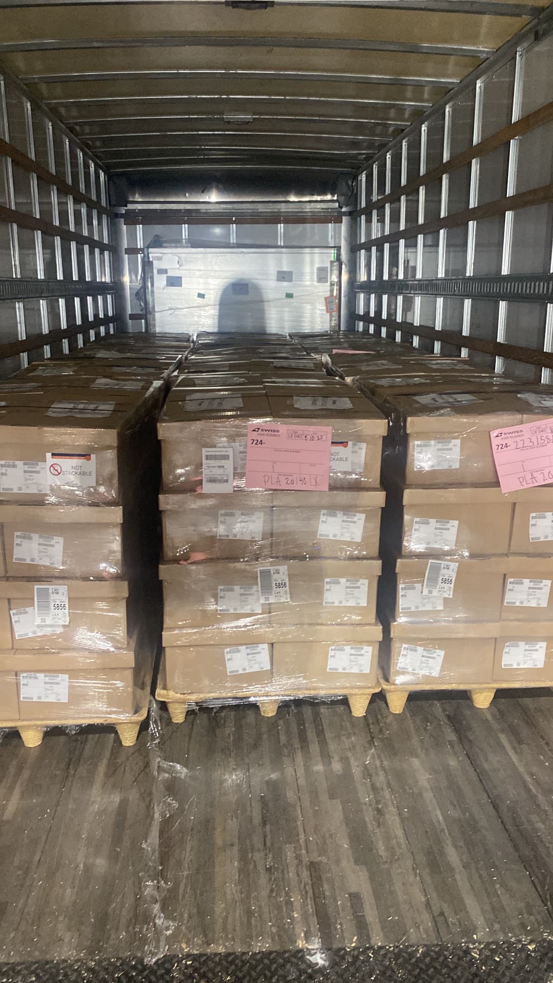 A real shipment of palletized cartons loaded inside a box truck