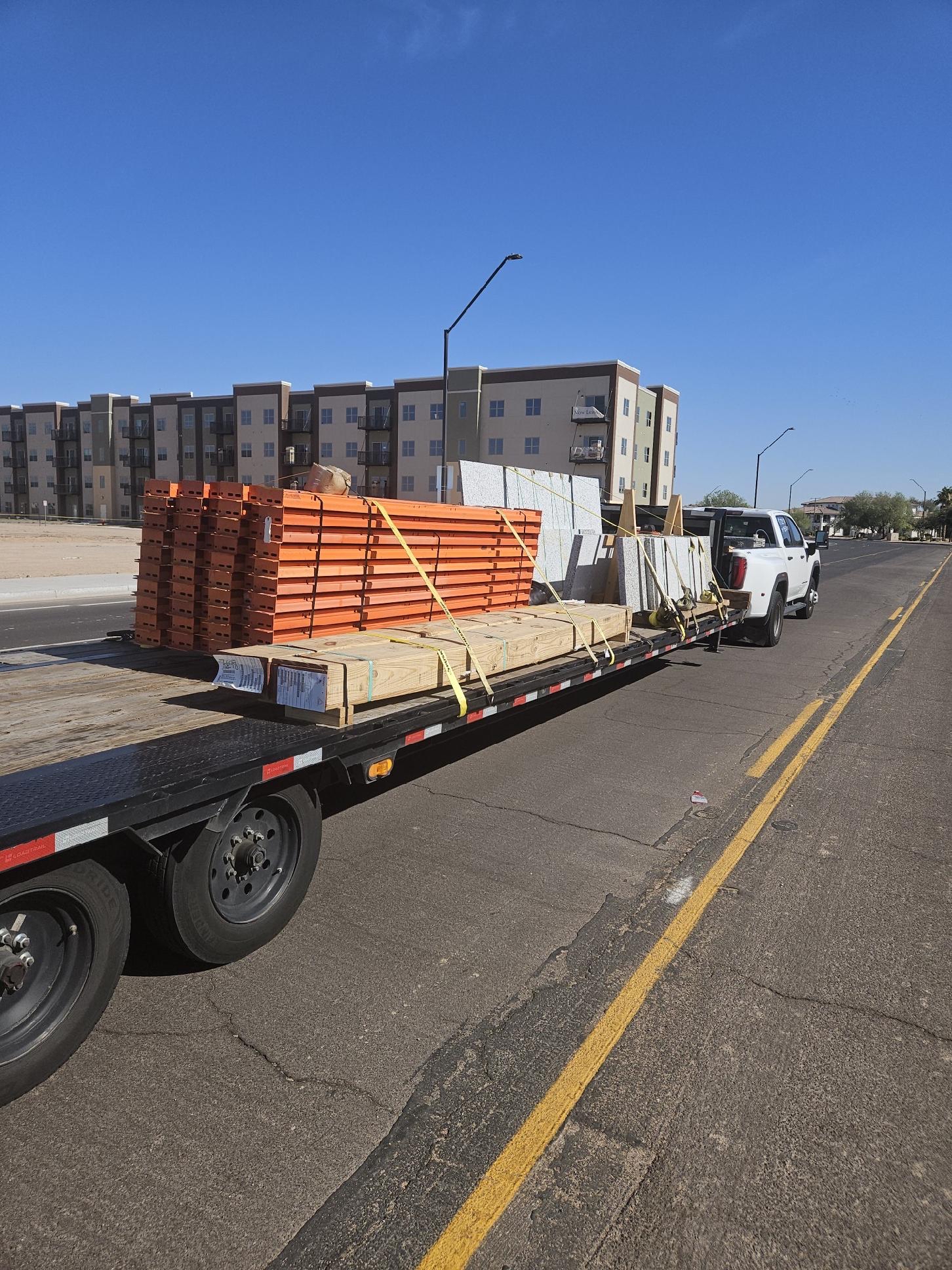 A real hotshot load of building materials secured to a flatbed trailer